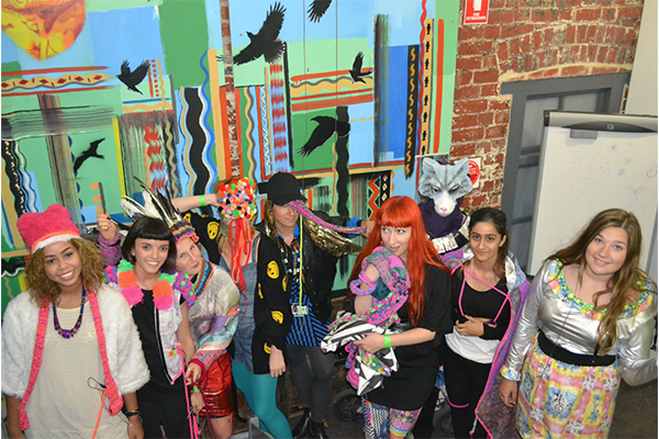 A photo of young artists who worked with artists Kate Geck and Tara Pattenden to create interactive sound constumes using soft circuits, digitally printed textiles, machine knitting, sound and animation. At SIGNAL Summer Arts program in 2014.